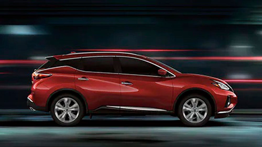 2023 Nissan Murano shown in profile driving down a street at night illustrating performance. | Banister Nissan of Chesapeake in Chesapeake VA